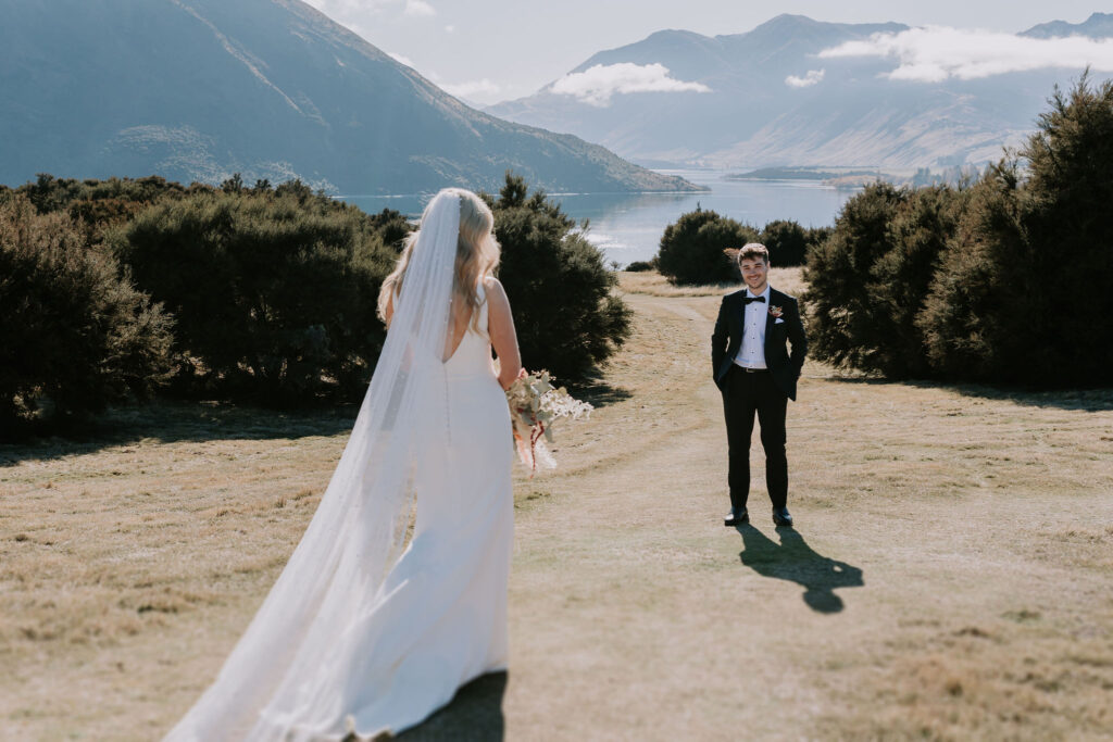 Bride and Groom having first look with mountains in the background