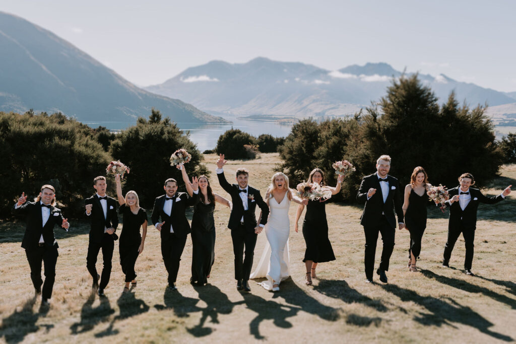 Bridal party having fun with hands in the air