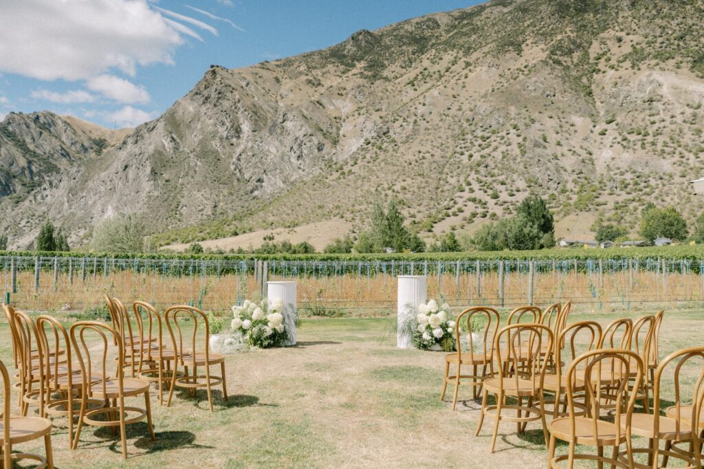 Empty ceremony chairs and floral pillars set up in the vineyard at Mt Rosa
